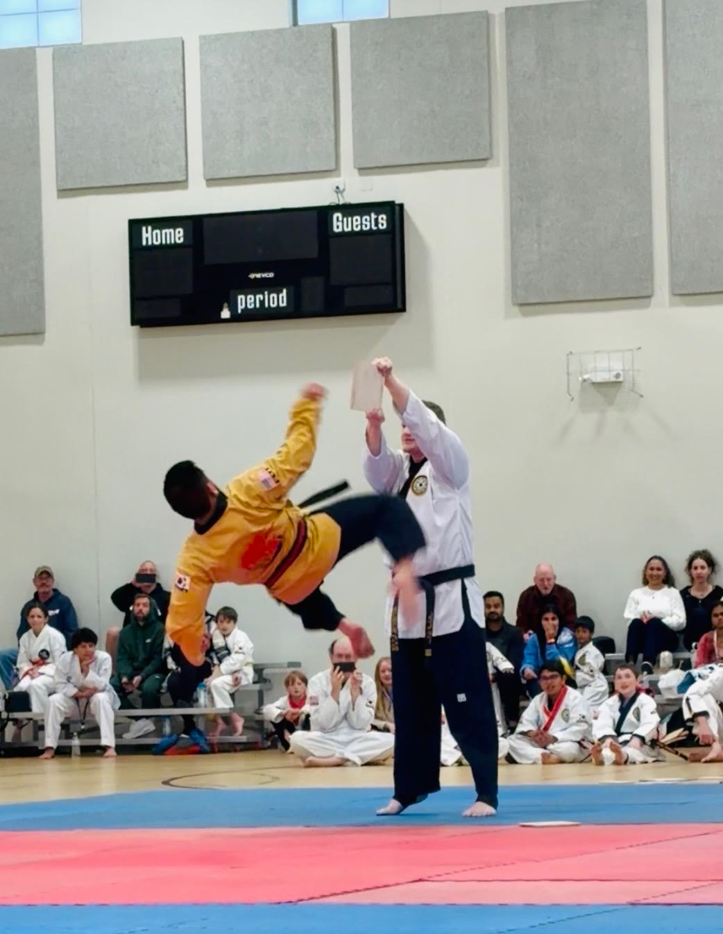 Student kicking breaking board